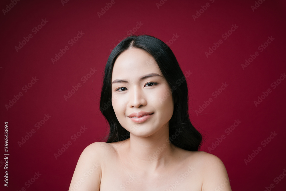 Beautiful young asian woman with clean perfect skin natural make up isolated on red background. Beautiful young asian woman with clean perfect skin natural make up isolated on red background.