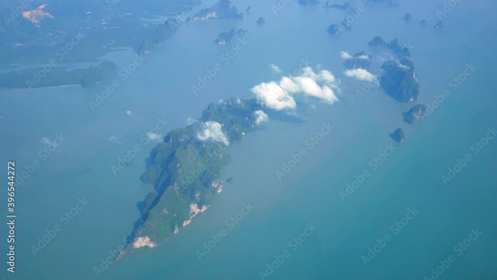 Travel Video View from the airplane window over the wings and engines The aircraft are take off or flying through island and Good weather transportation concept 4K Resolution wide angle shot. Travel Video View from the airplane window over the wings and engines The aircraft are take off or flying through island and Good weather transportation concept 4K Resolution wide angle shot.