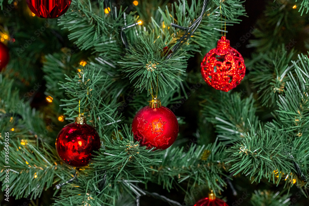 Christmas tree with garlands and red balls in the living room, beautiful new year background Christmas tree with garlands and red balls in the living room, beautiful new year background