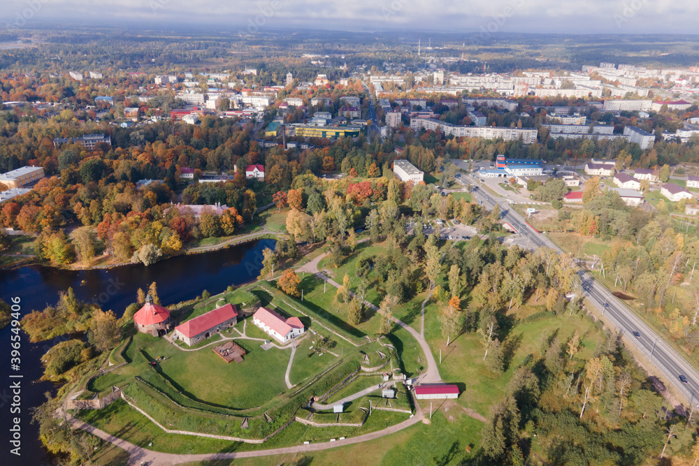Aerial view of ancient fortress Korela in priosersk with river and park in golden autumn, red and orange colours