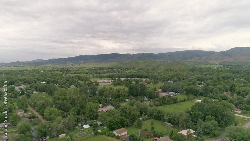 WS AERIAL Drone POV Aerial view of landscape with green trees and buildings WS AERIAL Drone POV Aerial view of landscape with green trees and buildings
