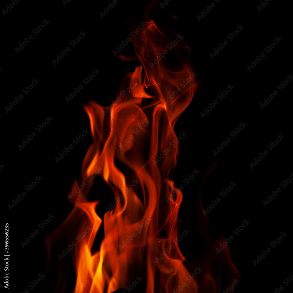 Fiery flame with sparks on a black background. Texture (element) for barbecue or cooking. Fiery flame with sparks on a black background. Texture (element) for barbecue or cooking.