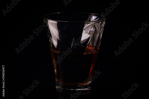 whiskey in a glass on a black background