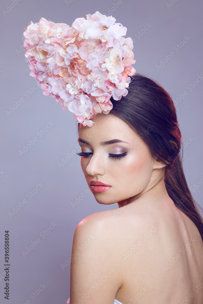 Closeup beauty rear portrait. Beautiful brunette young woman with spring flowers. Beauty Face.