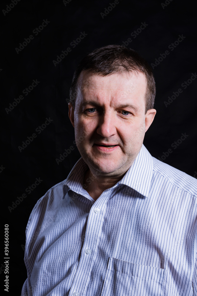 Middle aged solid man dressed in shirt studio portrait