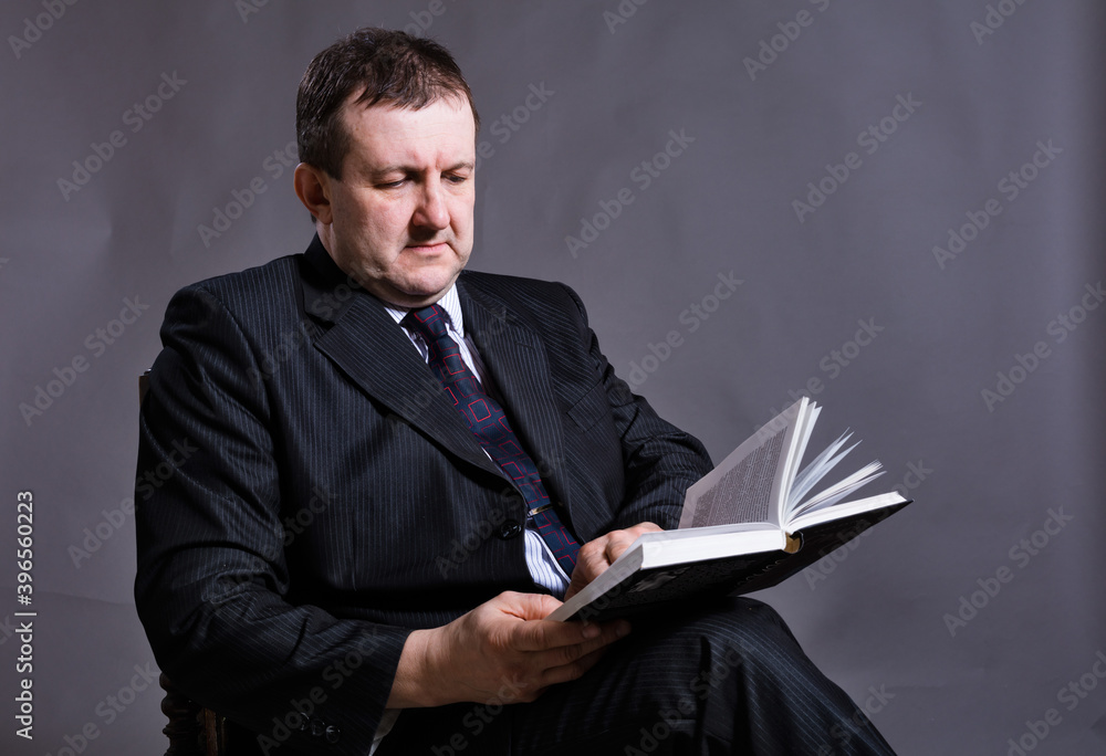 Middle aged solid professor with book Middle aged solid professor with book