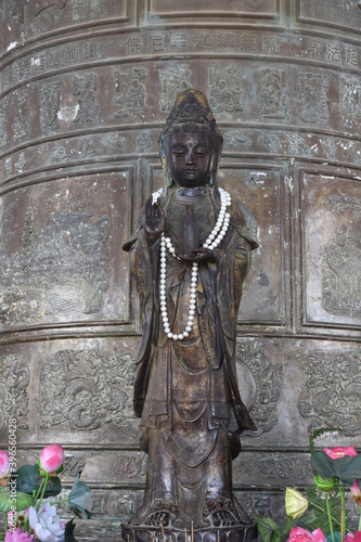 Standing Buddha in Karana Mudra in Linh Phuoc Temple Bell Tower, Da Lat, Vietnam photo