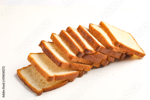 Cut of loaf bread on white against white background