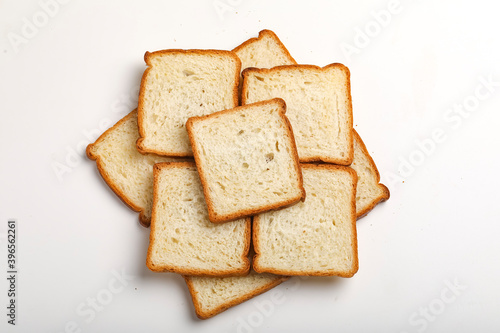 Cut of loaf bread on white against white background