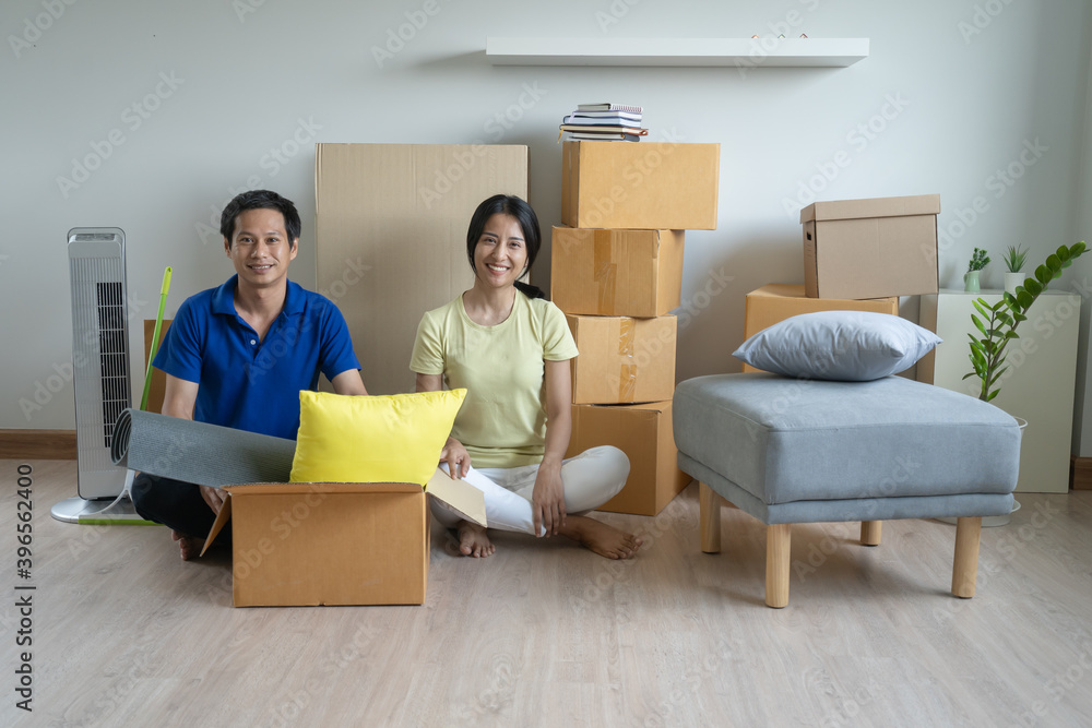 Asian couple lover unpacking thing after relocation to new apartment. Asian couple lover unpacking thing after relocation to new apartment.