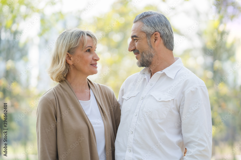 Elderly couple lifestyle concept. Husband and wife looking at each other face nature background Elderly couple lifestyle concept. Husband and wife looking at each other face nature background