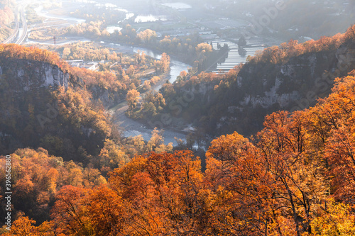 colorful landscape perspective view from mountains to river and village in autumn