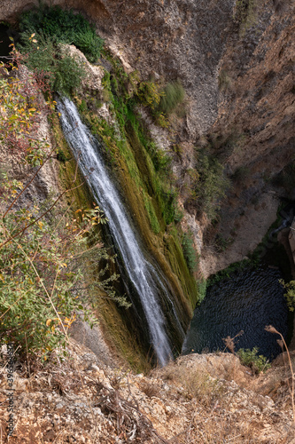 HaTanur waterfall flows from a crevice in the mountain and is located in the continuation of the rapid, shallow, cold mountain Ayun river in the Galilee in northern Israel