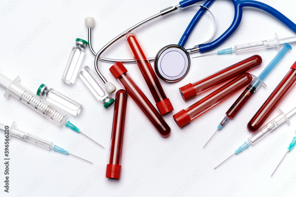 medical ampoule vials, test tubes, syringes and stethoscope over light grey or white background medical ampoule vials, test tubes, syringes and stethoscope over light grey or white background