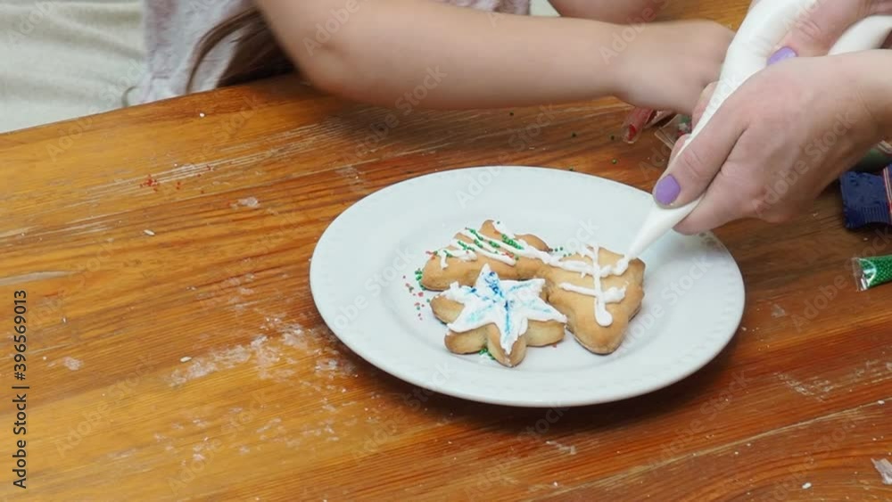 Merry Christmas and Happy Holidays. Family preparation holiday food. Mother and daughter cooking Christmas cookies. Merry Christmas and Happy Holidays. Family preparation holiday food. Mother and daughter cooking Christmas cookies.