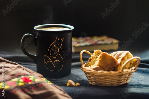 embroidery and a cup of coffee on a black canvas notebook and cookies Ukrainian traditions