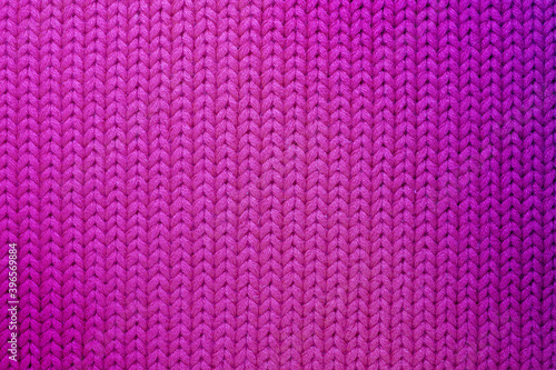 Fuchsia color knitted texture closeup. Abstract woolen fabric background. 