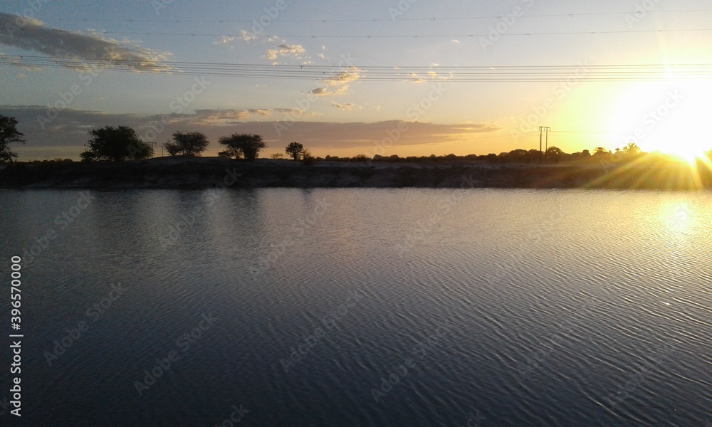 Sunset over a water pan in Oshana region, Namibia. Sunset over a water pan in Oshana region, Namibia.