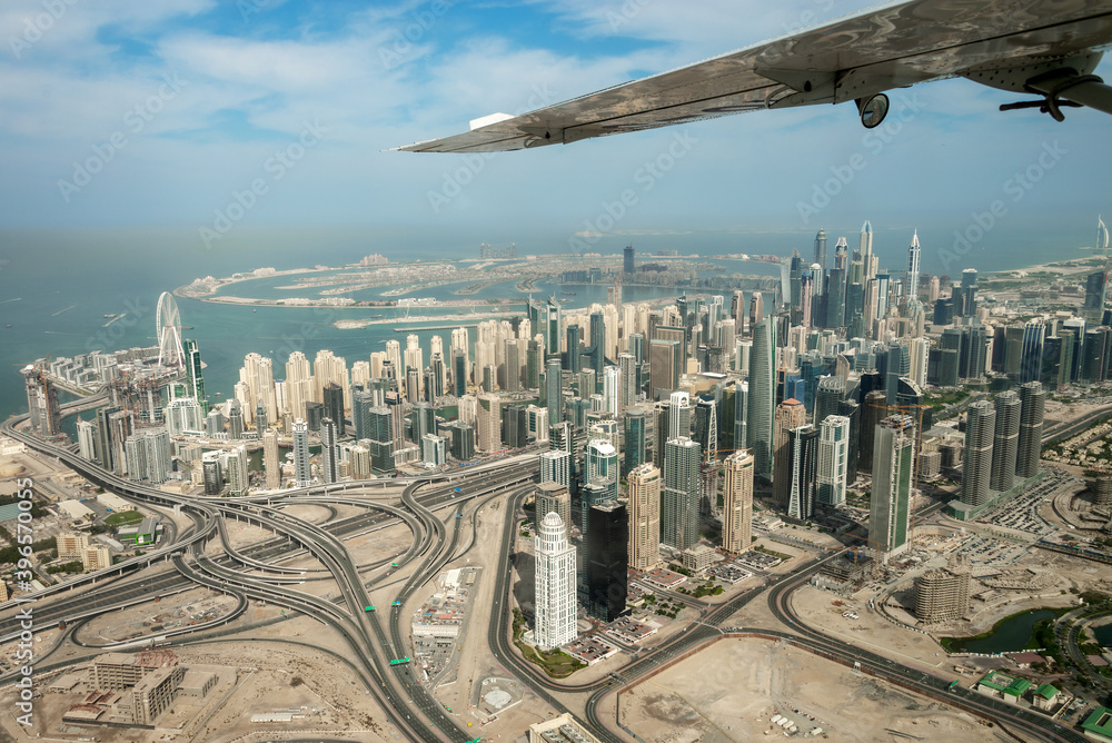 Aerial view of Dubai Marina skyline, road interchange and Palm Jumeirah, United Arab Emirates
