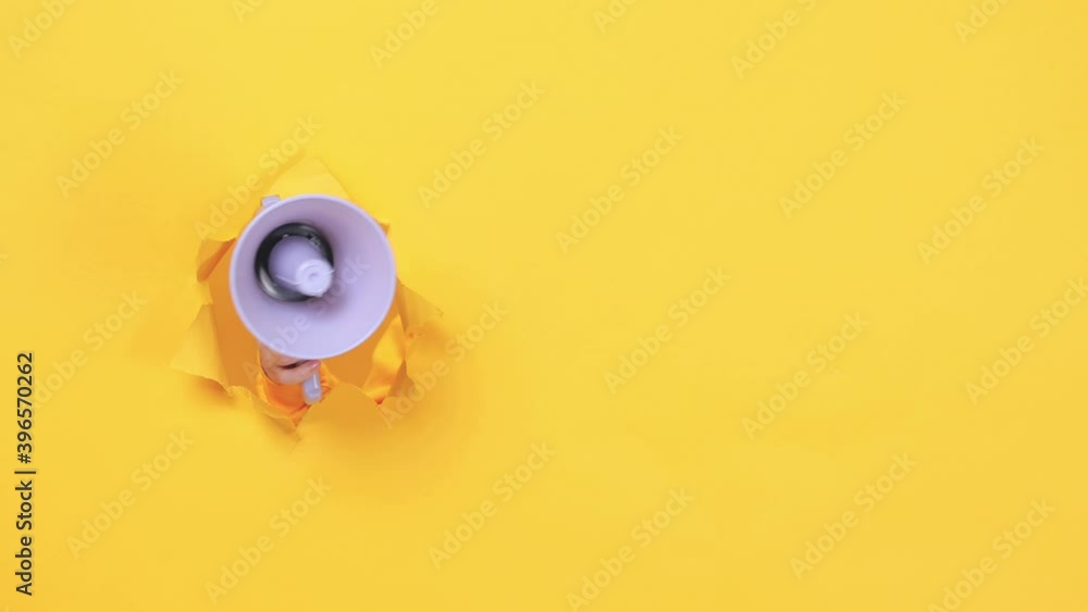 Woman hand arm hold megaphone isolated through torn yellow background Copy space advertisement place for text or image workspace mock up Hot news announce discounts sale hurry up communication concept Woman hand arm hold megaphone isolated through torn yellow background Copy space advertisement place for text or image workspace mock up Hot news announce discounts sale hurry up communication concept