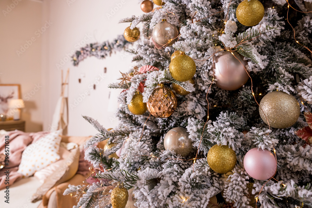 Christmas toys on a fir-tree close up with interior background Christmas toys on a fir-tree close up with interior background