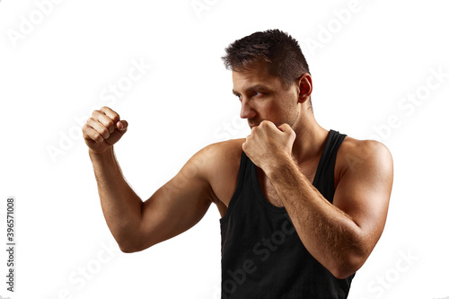 handsome strong muscular man showing fists isolated on white background.