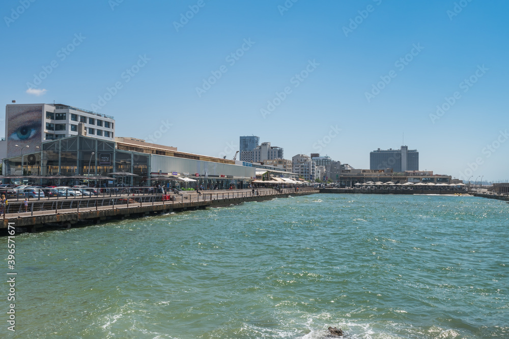 View of the city of Tel Aviv from Abrasha Park across the bay in Jaffa in Tel Aviv, Israel, with palm trees and skylines.