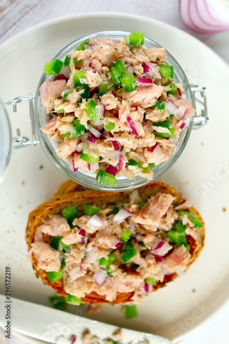 Sandwich with tuna and vegetables for snack on light background. Top view with copy space.