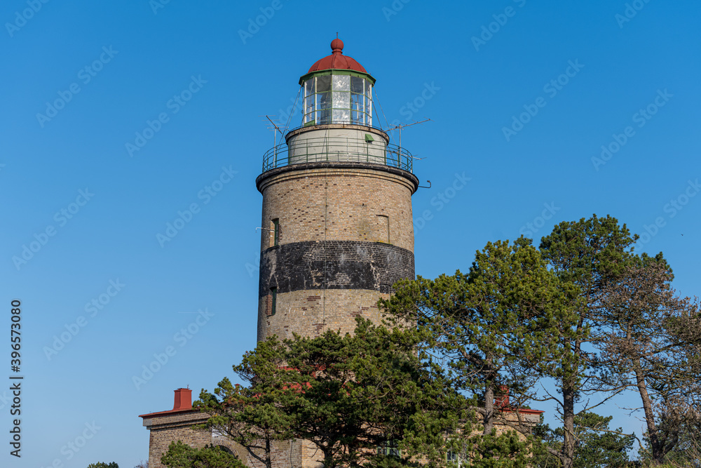 A brick lighthouse with a bright blue sky in the background. Picture of Falsterbo Lighthouse built in 1796, Scania, Sweden