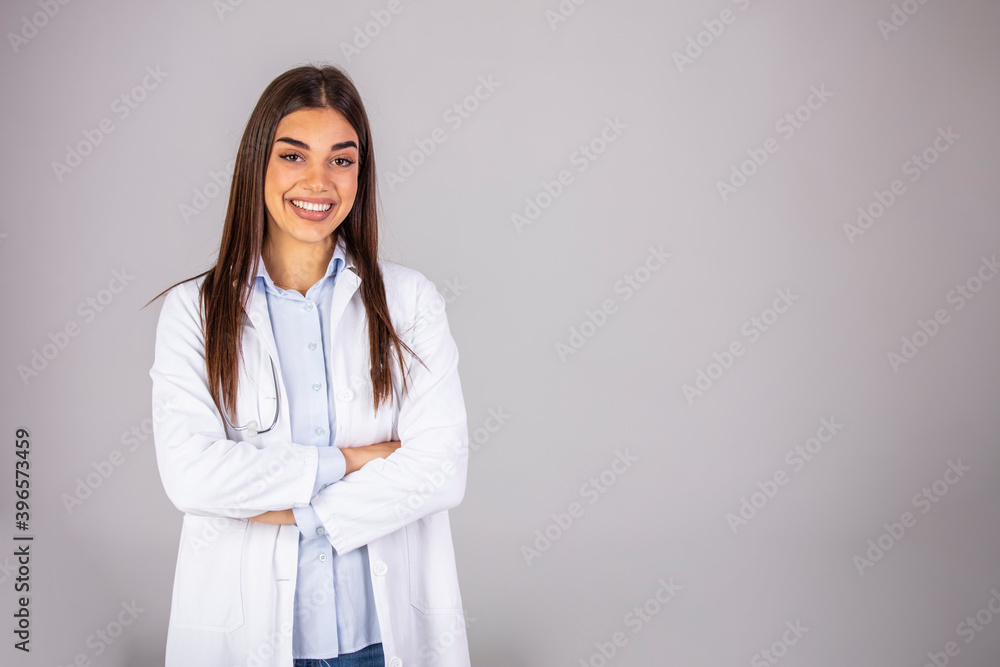 Woman doctor in white uniform standing with crossed arms. isolated female portrait. Portrait of happy successful female doctor. Woman hospital worker looking at camera and smiling, studio Woman doctor in white uniform standing with crossed arms. isolated female portrait. Portrait of happy successful female doctor. Woman hospital worker looking at camera and smiling, studio