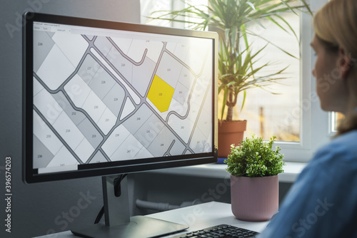 woman working with digital land registry database on computer in office