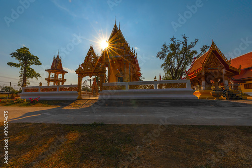 The sun goes down behind the temple at Wat Prathumthong. Ban Nong Bua Noi, Suwannakhuha, Nong Bua Lamphu, Thailand photo