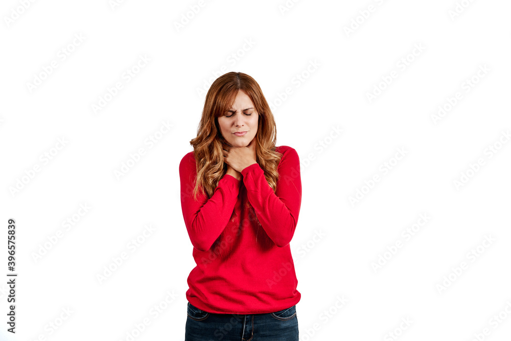 Beautiful young woman dressed in a red sweater, with a sore throat, isolated on a white background. Beautiful young woman dressed in a red sweater, with a sore throat, isolated on a white background.