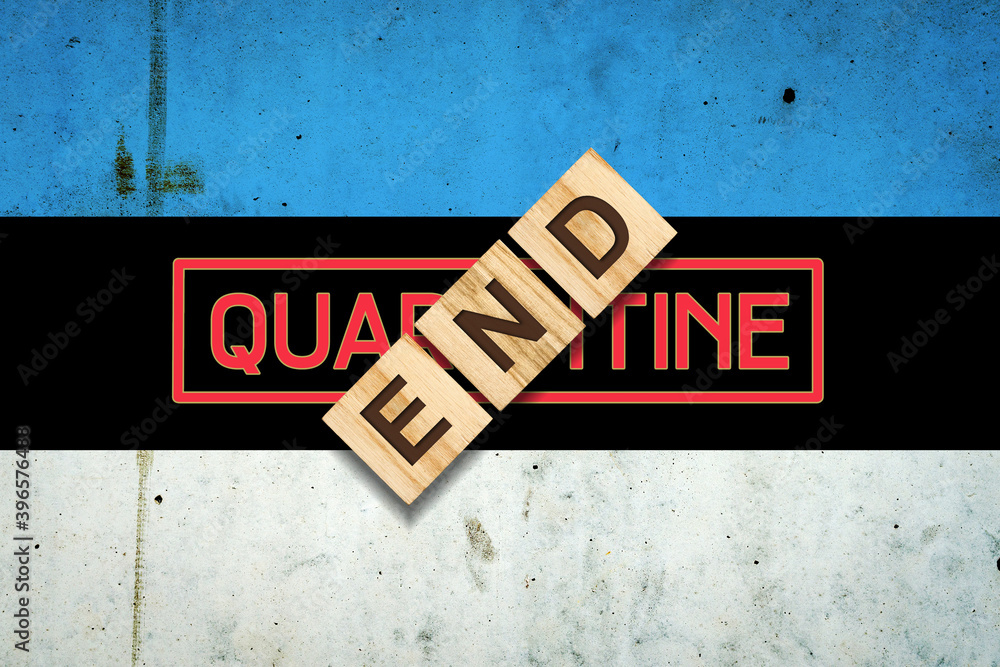 End of quarantine. The inscription on wooden blocks on the background of the flag of Estonia. The end of the pandemic. Business. End of quarantine. The inscription on wooden blocks on the background of the flag of Estonia. The end of the pandemic. Business.