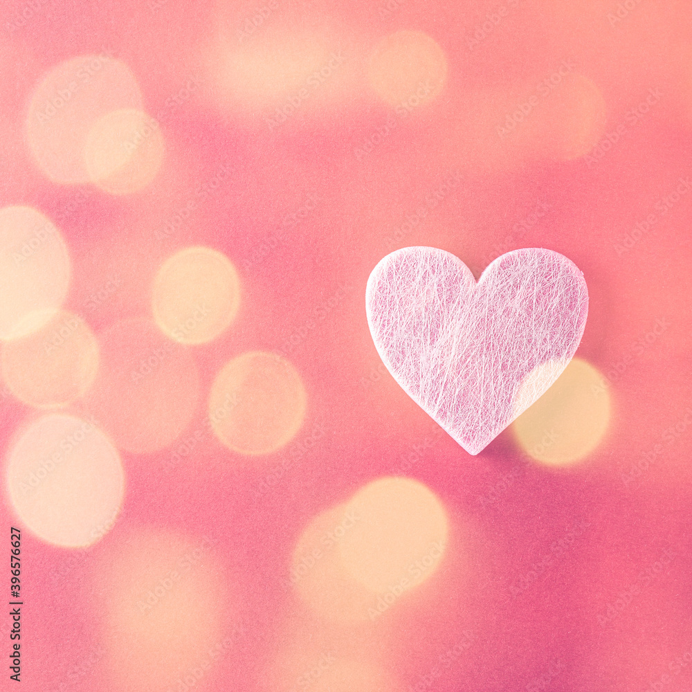 Valentine's Day background with bokeh. Pink heart over red. Valentines day concept. Flat lay, top view, copy space