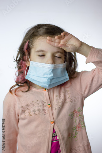 Tired kid girl with a mask ...