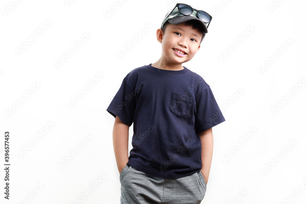 Stylish cute little Asian boy wearing cap and sunglasses posing on white background Stylish cute little Asian boy wearing cap and sunglasses posing on white background