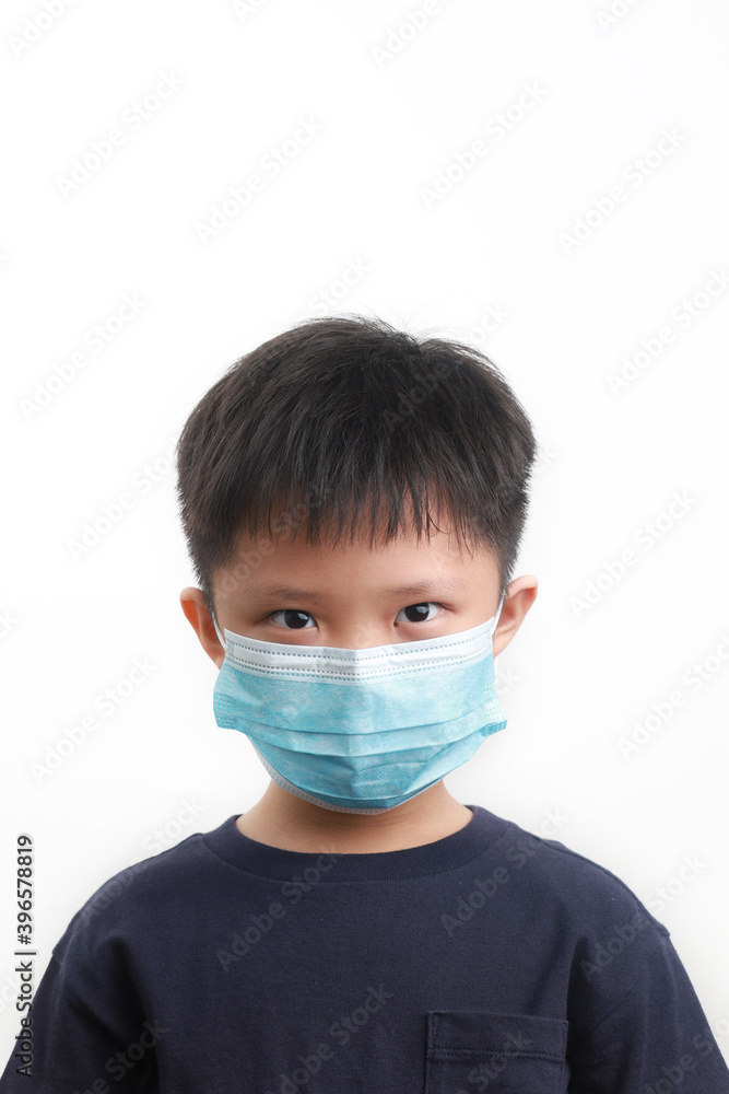 Portrait of 9-year-old boy wearing a protective mask against a white background. Coronavirus, Covid-19 and pandemic concept. Portrait of 9-year-old boy wearing a protective mask against a white background. Coronavirus, Covid-19 and pandemic concept.