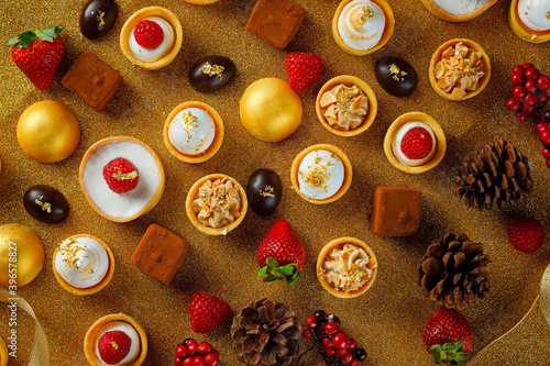 Selection of delicious Christmas desserts presented on a gold background