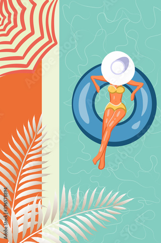 Top view of a woman in yellow swimsuit and sun hat swimming in her pool. Sun umbrella and tropical leaves