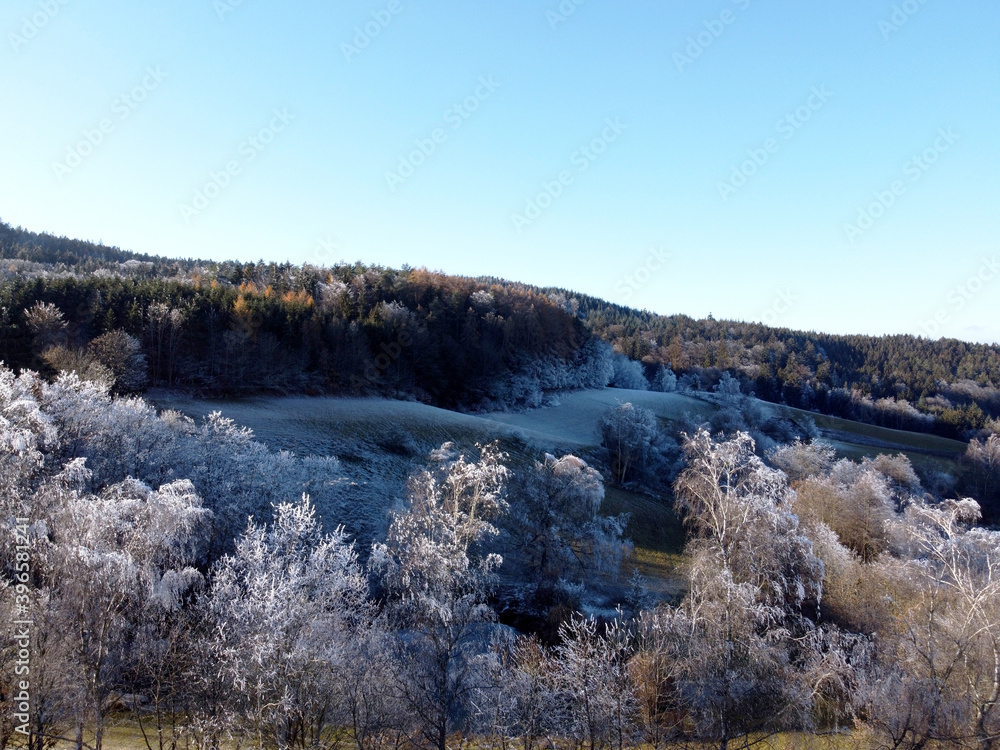 Aerial photos of a field in winter landscape on a sunny cold day