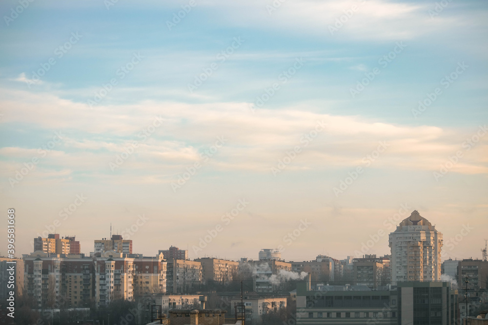 City on the background of the cloudy blue sky.