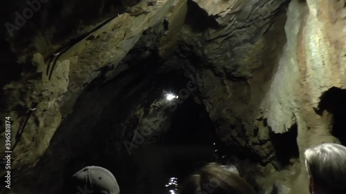 Tourists explore the Punkva Caves, subterranean boat ride in the Moravian Karst, Czech Republic, Czechia.