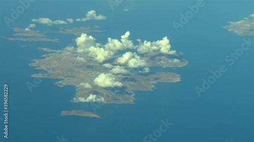 Flying over the Greek Islands. Airliner flies over Mikonos, Greek Islands, Aegean Sea. photo