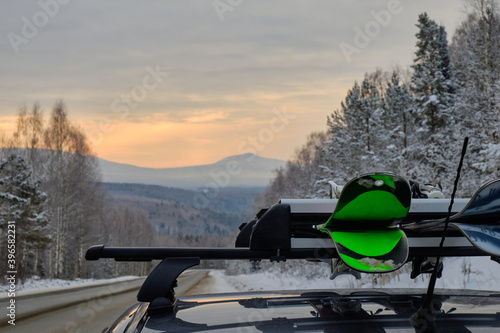 Roof rack of a ski and snowboard car with a mountain background in winter