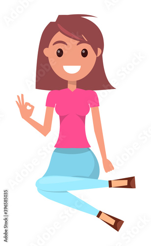 Young brown-haired woman wearing pink t-shirt and jeans sits on floor. Smiling girl show ok sign. Pretty female posing. Portrait of happy woman gesturing hand, okey symbol. Cartoon flat character