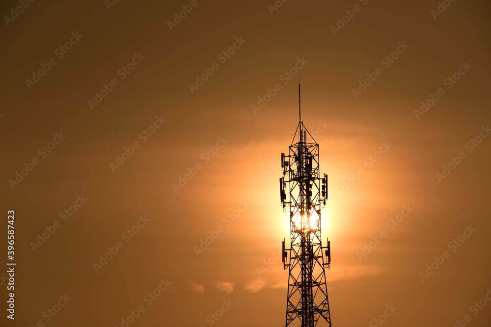 Telecommunication tower Antenna and satellite dish at sunset sky backgroundommunication tower Antenna and satellite dish at sunset sky background