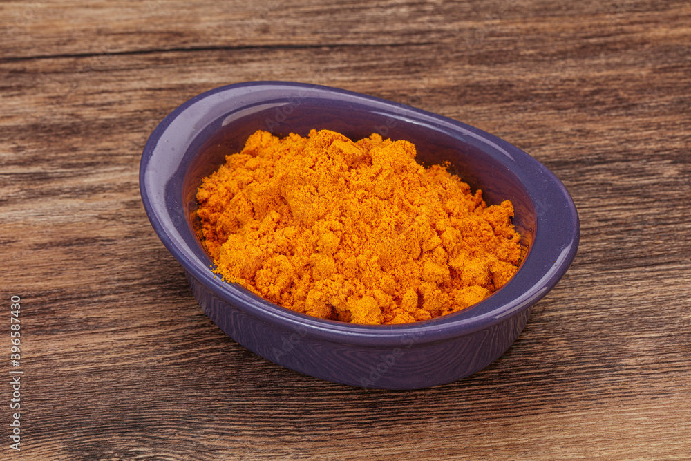 Tumeric powder in the bowl Tumeric powder in the bowl