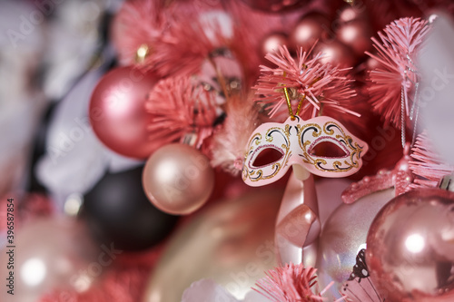 pink christmas balls and carnival mask