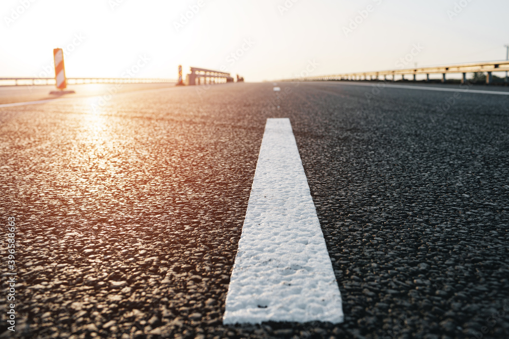 White marking line on asphalt road on highway